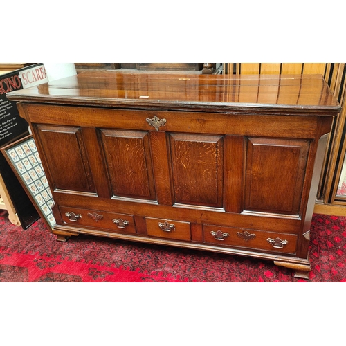 871 - An 18th century oak mule chest with panelled front Three draws below hinged lid. 142 x 87 x 58cm