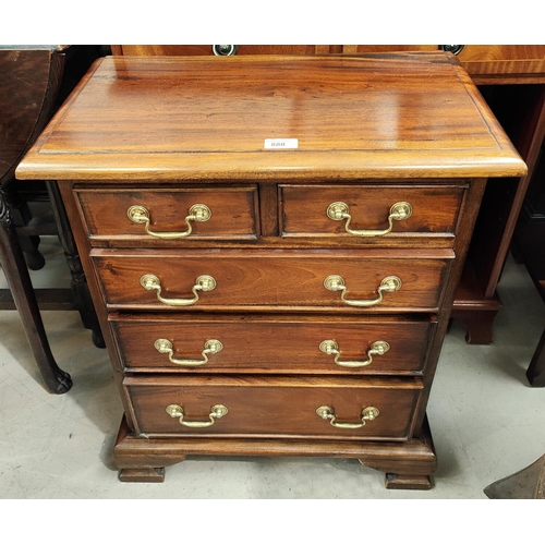 880 - A mahogany reproduction dwarf chest of 3 long and 2 short drawers; a similar 2 height bookcase