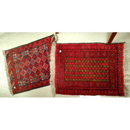 887 - Two small modern handknotted Persian rugs, the smaller length 60cm, the larger with crosshatched cen... 