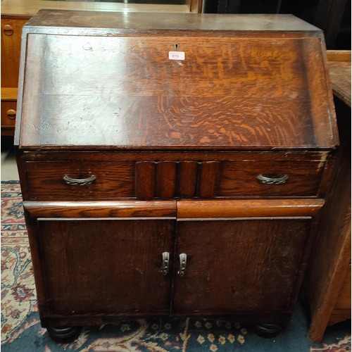 910 - A 1930's oak fall front bureau with double cupboard under