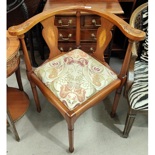 989 - A reproduction inlaid corner fitting armchair with floral cushion