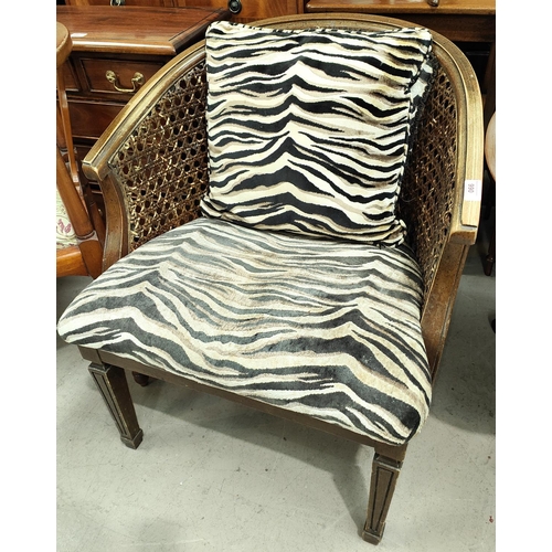 990 - A 1930's Bergere tub shaped armchair with Zebra pattern seat and cushion