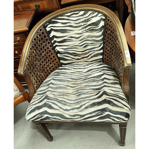 990 - A 1930's Bergere tub shaped armchair with Zebra pattern seat and cushion