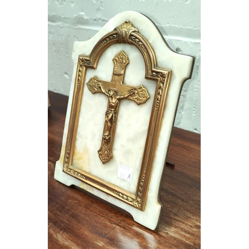 185A - A gilt mounted on marble crucifix in gilt frame on brass back plate, 21cm