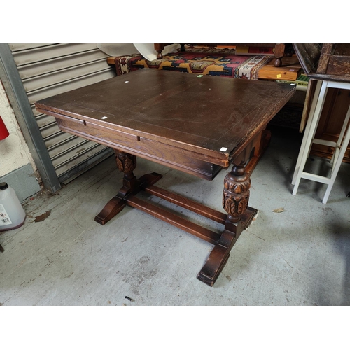 840 - An oak draw leaf dining table with bulbous legs and an oak carved wooden buffet sideboard with cupbo... 