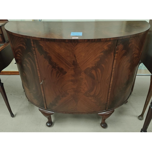 862 - A mahogany quarter veneered bow fronted side cabinet with interior shelf Length 122cm 