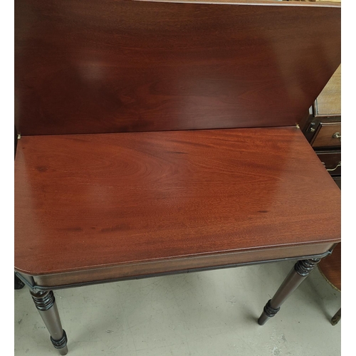 869 - A mahogany tea table with turned legs, rounded rectangular folding top. 