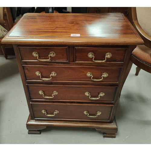 880 - A mahogany reproduction dwarf chest of 3 long and 2 short drawers; a similar 2 height bookcase