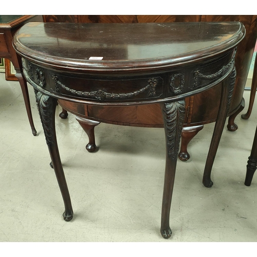 909 - A 19th century mahogany demilune side table with carved swag decoration to the front, carved legs wi... 