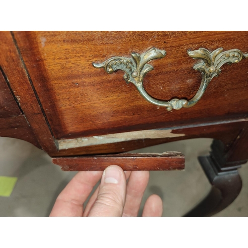 975 - A mahogany desk with letter rack, drawers behind, and three below, length 91cm; an oak armchair