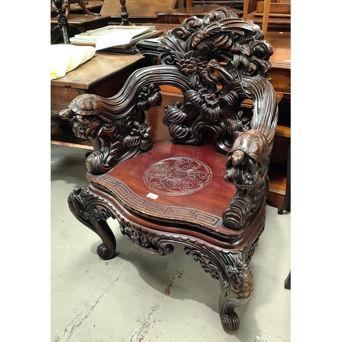 985 - An impressive Chinese/Japanese elaborately carved softwood tub arm chair with Crane to the back, Tor... 