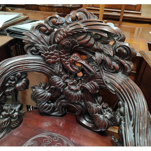 985 - An impressive Chinese/Japanese elaborately carved softwood tub arm chair with Crane to the back, Tor... 