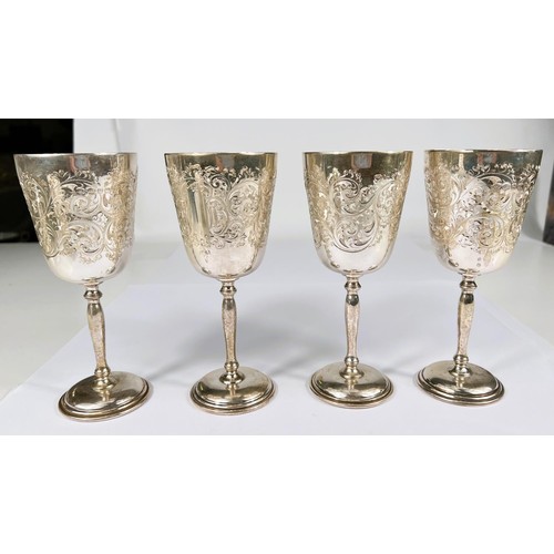 651B - A hallmarked silver set of 4 goblets with gilt interiors and chased acanthus decoration, of tap... 