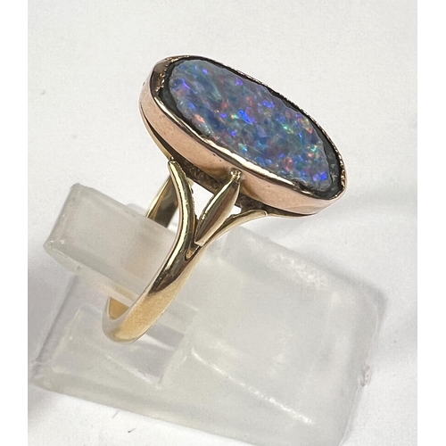 609 - An 18ct gold oval shaped black opal (14mm x 9mm) doublet ring, 3.37gms, ring size K/L.