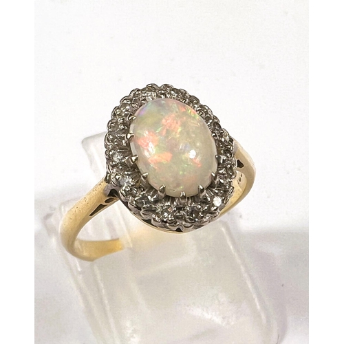 610 - Gold, hallmark worn ring with opal (good quality) 9mm x 7mm, surrounded by 16 diamonds, 3.8gms, ring... 