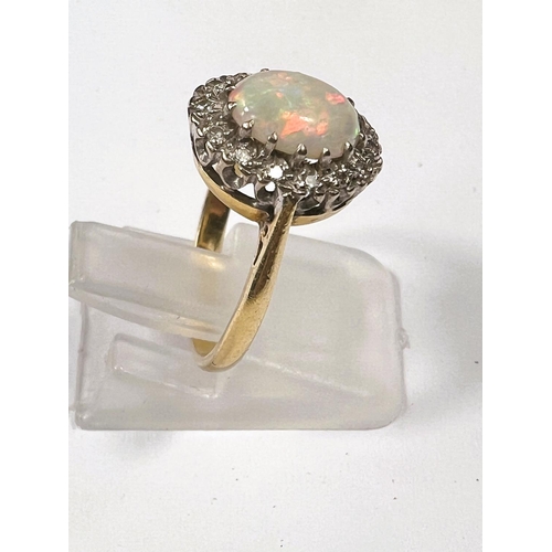 610 - Gold, hallmark worn ring with opal (good quality) 9mm x 7mm, surrounded by 16 diamonds, 3.8gms, ring... 