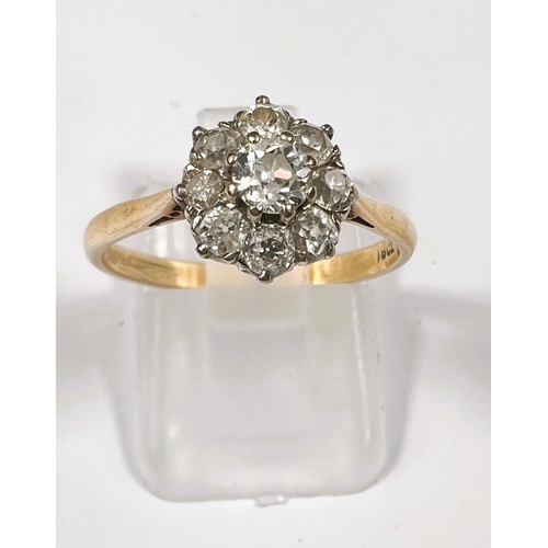 615 - An 18 carat hallmarked gold ring set central diamond, 5mm approx., surrounded by 8 smaller stones, 3... 