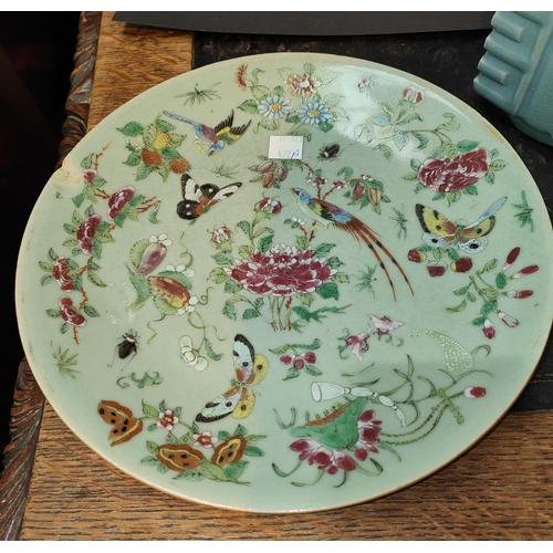 427A - A mid 19th century Chinese celadon plate mark to back, decorated With birds butterflies and flowers ... 