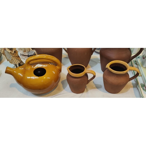 439B - Two vintage terracotta milk jugs with yellow rims and an unusual wine pot in yellow glaze