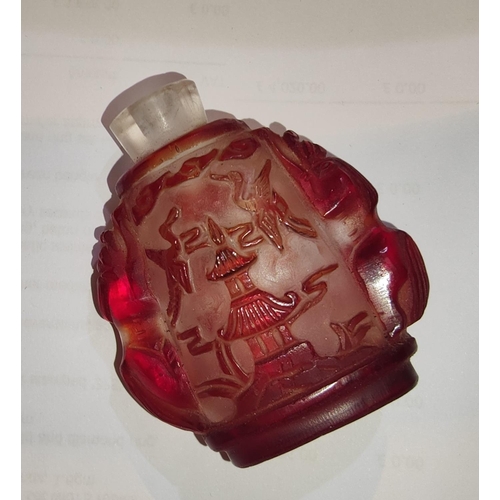 527 - A Chinese red glass snuff bottle with Chinese characters, bamboo and animals, in relief, 6.5cm