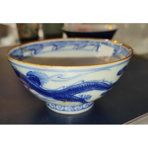 528A - A Chinese blue and white rice bowl with dragon decoration, character mark to base