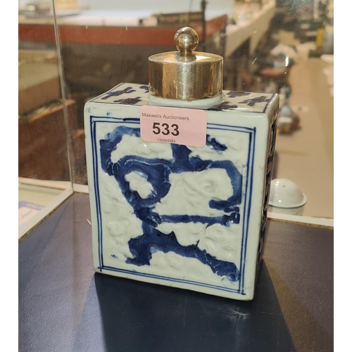 533 - An 18th century Chinese blue an white square tea caddy with relief decoration, later hallmarked silv... 