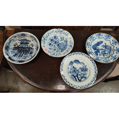 555 - Four 18th century Dutch Delft plates, blue and white, variously decorated with flowers and trees all... 