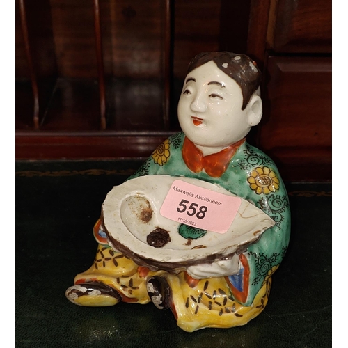 558 - A Chinese ceramic polychrome figure of seated girl holding very large oyster shell decorated with se... 