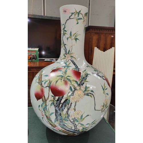 559 - A very large Chinese bottle vase decorated with polychrome peaches and flowers on branches with seal... 