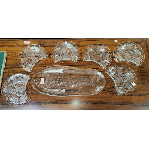 572 - A glass elongated fish platter; a set of 6 demilune side dishes with etched decoration of thistles