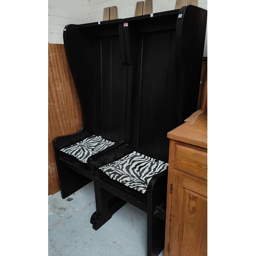 878 - A pair of unusual high back chairs in black finish