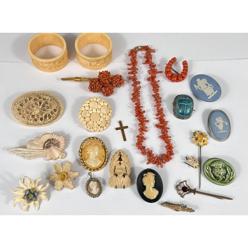 737 - A selection of vintage costume jewellery:- Cameo brooches and pendant; carved bone brooches, a coral... 