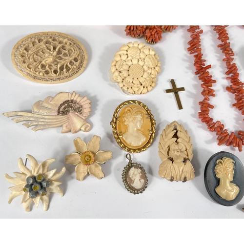 737 - A selection of vintage costume jewellery:- Cameo brooches and pendant; carved bone brooches, a coral... 