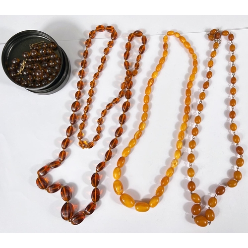 742 - Two amber coloured necklaces with graduating beads; a clear amber coloured glass bead necklace and a... 