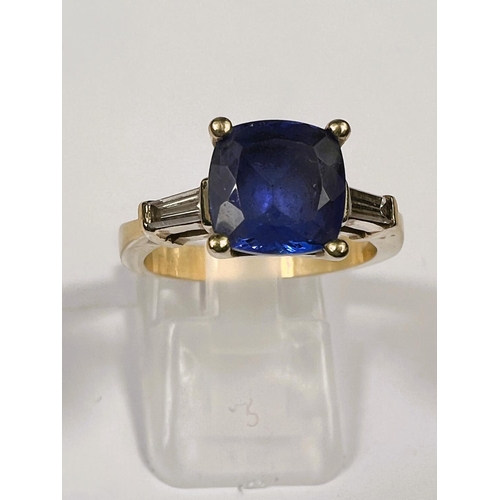 664 - A modern ladies dress ring set square cut tanzanite with diamond baton to each shoulder, the yellow ... 