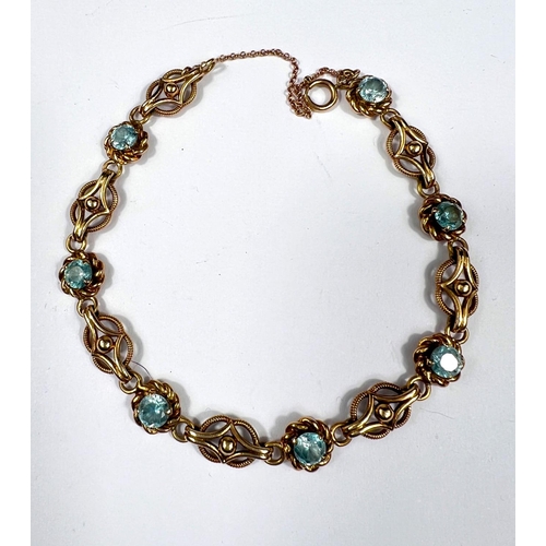 705 - A Victorian yellow metal bracelet set alternating blue topaz and filigree links, unmarked, tests as ... 