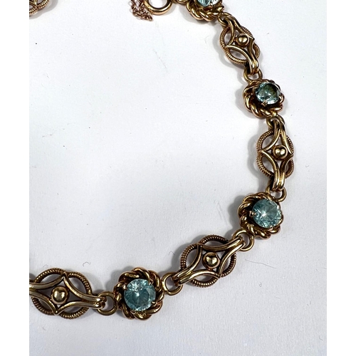 705 - A Victorian yellow metal bracelet set alternating blue topaz and filigree links, unmarked, tests as ... 