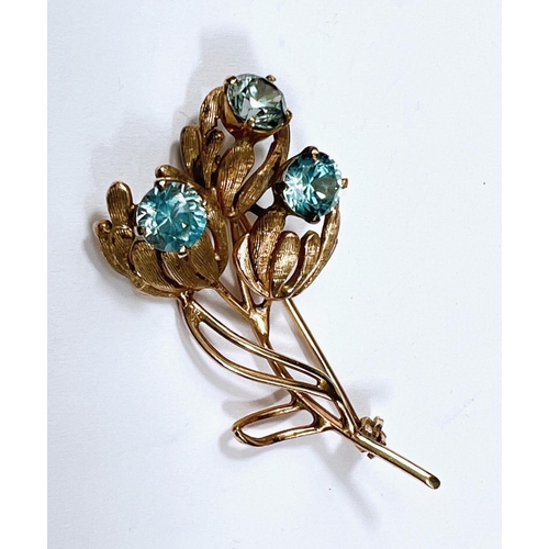 706 - A 9 carat hallmarked gold spray brooch the triple stem set 3 blue topaz, 7gm