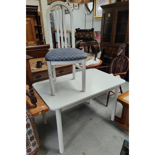 863 - A white kitchen table and four white hoop back chairs