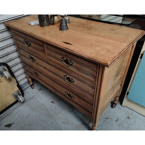 891 - An Edwardian stripped wood chest of 2 long and 2 short drawers