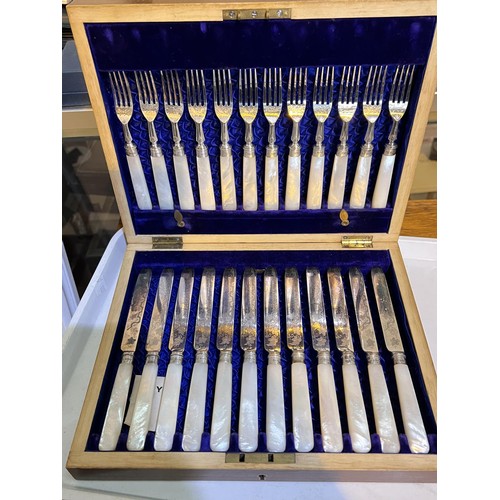 603 - A cased set of 12 mother of pearl and etched silver plated knives and forks with hallmarked silver c... 