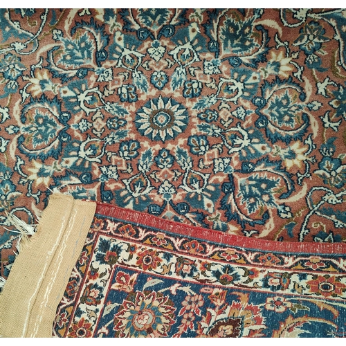 838 - A hand knotted Isfahan style rug with red ground  with blue highlights, width 147cm