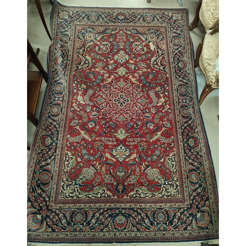 839 - A hand knotted Isfahan style rug with blue ground red highlights width 133cm