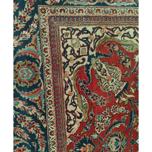 839 - A hand knotted Isfahan style rug with blue ground red highlights width 133cm