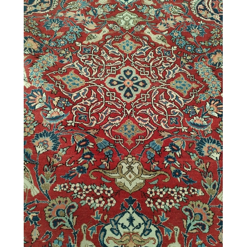 839 - A hand knotted Isfahan style rug with blue ground red highlights width 133cm