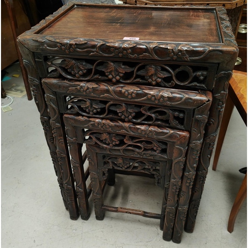 986 - A 19th century Chinese carved wood nest of four occasional tables with scrolling leaves and vines, g... 