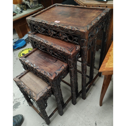 986 - A 19th century Chinese carved wood nest of four occasional tables with scrolling leaves and vines, g... 