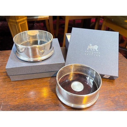 653 - Two boxed silver wine coasters 