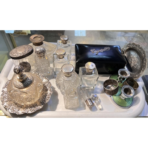 764A - A selection of silver topped scent bottles, an ebonised cigarette box with silver applied, other whi... 