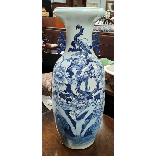 544A - A 19th century Chinese floor standing vase in blue and white with piercing to the neck, height 59cm